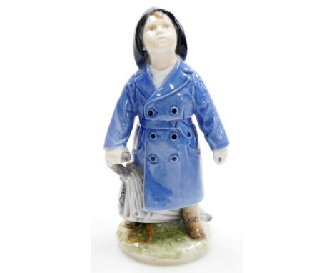 A Royal Copenhagen porcelain figure of young boy in raincoat with umbrella, on a circular base, stamped in green to underside