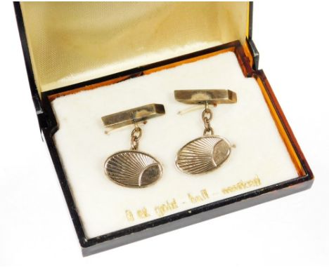 A pair of 9ct gold cufflinks, each with oval shield with engine turned fan decoration on bar back with curb links, 4.4g, boxe