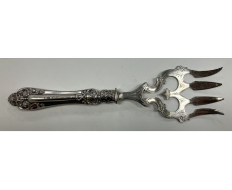 A sterling silver handled bread fork with four-pronged plated end, 24.5 cm long
