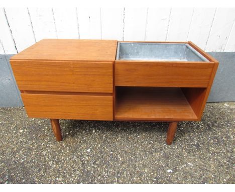 A teak planter and drawers raised on turned legs 