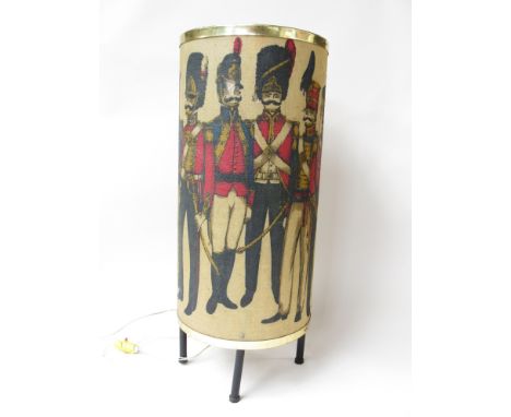 A 1960's floor lamp with printed shade with various soldiers dress uniform design 