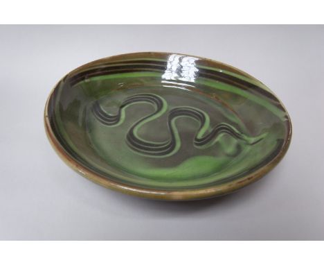MICHAEL CARDEW (1901-1983) (ARR) A Winchcombe Pottery oval pie dish with green glaze and finger wipe wave.  Impressed persona