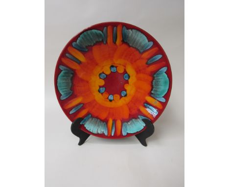 A Poole volcano range dish in reds, orange and green. 26.5cm diameter 