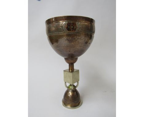 A copper and white brass chalice beaten cup with line detail, square knop over enamel and beaten copper foot. Unmarked, 21cm