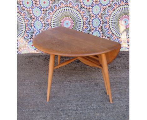 A light Ercol drop flap coffee table 