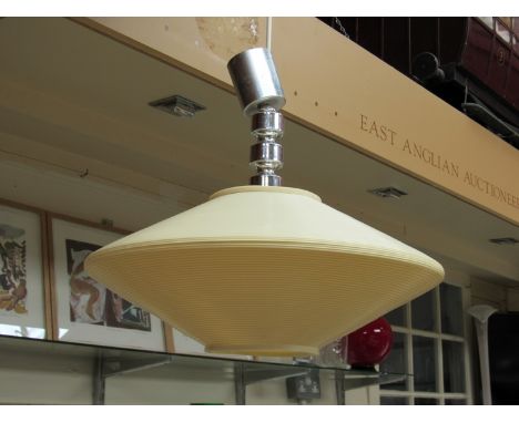 A ribbed plastic ceiling light of "flying saucer" form