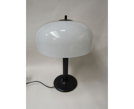 A table lamp with black metal base and perspex shade