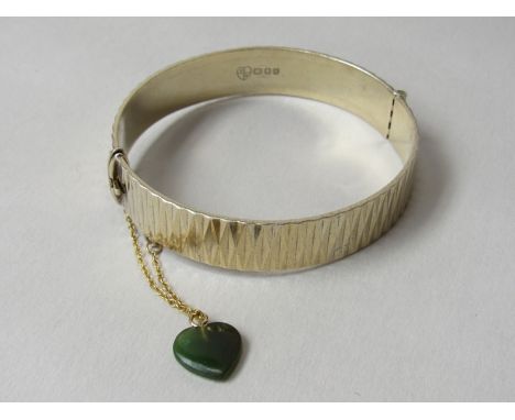 A 1960's modernist 22ct gold on silver bracelet with jade heart charm by F. Mansure Ltd. dated London 1967