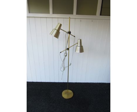 A brass standard lamp with twin adjustable spots 
