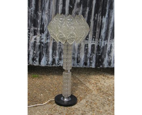 A textured glass and chromed metal lamp