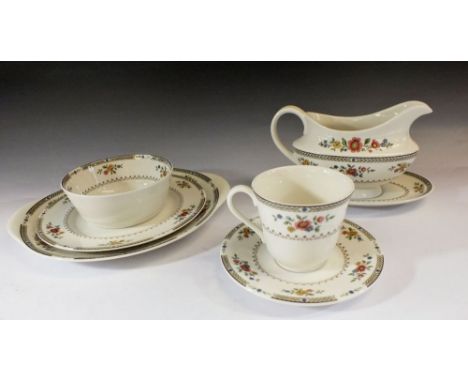 A Royal Doulton Kingswood tea and dinner service comprising: six dinner plates, six side plates, six bowls, cake plate, sauce