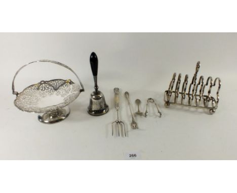 A group of silver plated items including bell, toast rack, cake fork, pickle fork etc.