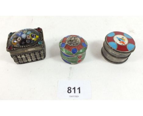 Two Eastern white metal and enamel circular pill boxes and a white metal box inset millefiroi glass top 