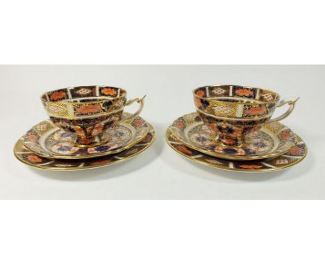 A pair of Royal Crown Derby Old Imari 9021 pattern trios, consisting two cups, two saucers, two side plates.   Date mark for 