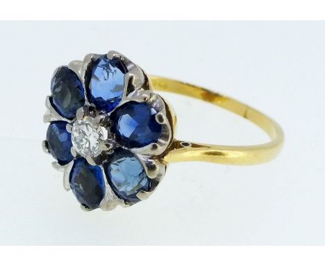 An 18 carat gold sapphire and diamond flower form cluster ring, size N/O, 4g 