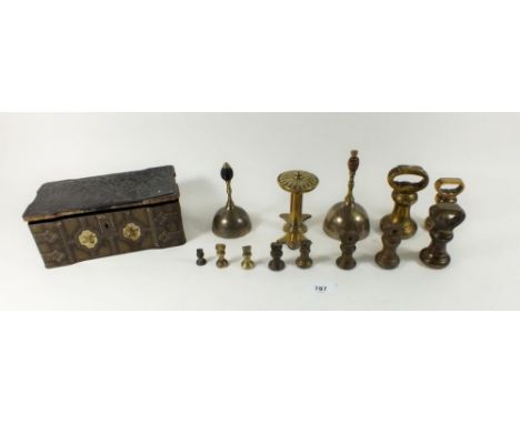 A box of old graded brass bell weights, two bells and a tie back 