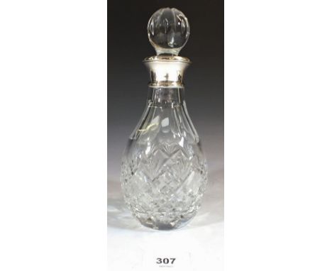 A cut glass liquor decanter with silver collar, 20cm 