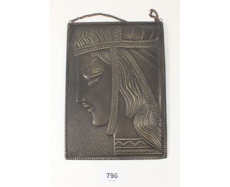 A Russian Art Deco style bronze finish brass plaque, with repousse decoration of a young girls face wearing Povyazka headdres