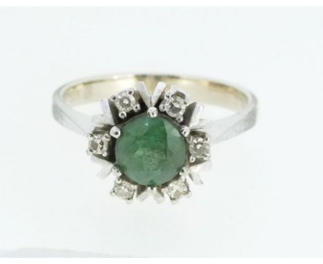 A 14 carat white gold ring set emerald within diamond surround, size O 