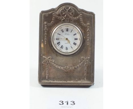 A Garrards small silver fronted mantel clock, 9cm tall, engraved presentation