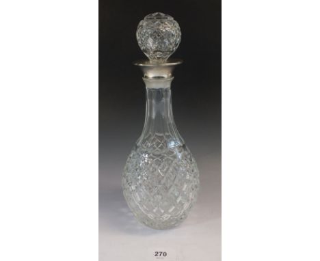 A cut glass decanter with silver plated collar 