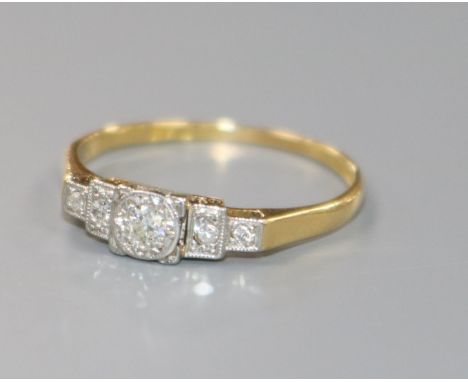 A 1920's/1930's 18ct gold, platinum and stepped graduated five stone diamond ring, size Q.