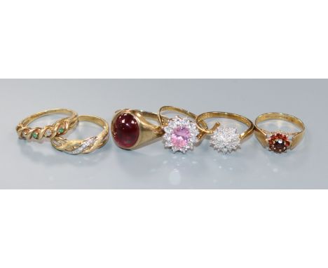 Five 9ct gold rings and one 10ct ring, including a gentleman's cabochon garnet set-ring, an emerald and diamond spiral-set ha