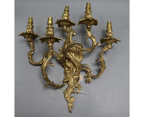 A brass five branch candelabra wall light