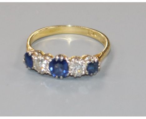 An 18ct gold and platinum, sapphire and diamond five stone ring, size M/N.