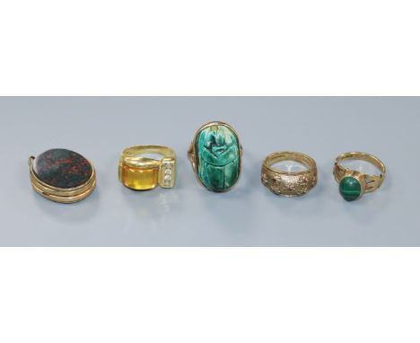 A 9ct gold carved turquoise scarab ring, a yellow metal citrine and paste ring, a 9ct gold and malachite ring, a yellow metal