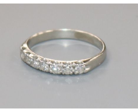 A white metal and seven stone diamond half eternity ring, size P.