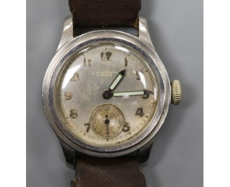 A mid 20th century stainless steel Longines mid size? manual wind wrist watch retailed by J.W. Benson, on associated strap.