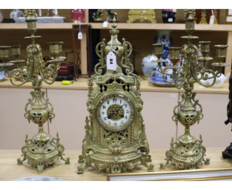 A gilt brass and enamel clock garniture Tallest piece measures 15cm