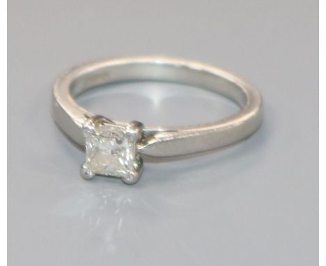 A platinum and solitaire princess cut diamond ring, size K.