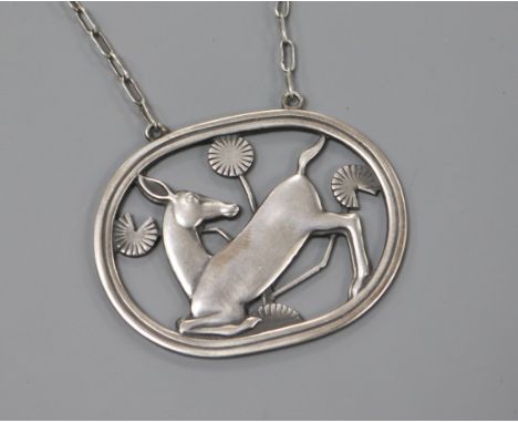 A Danish Georg Jensen sterling silver oval kneeling deer pendant on chain, no.95, 1933-1944 mark, 43mm.