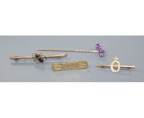 Two early 20th century 9ct gold brooches including gem set bug brooch, a yellow metal stick pin and one other brooch.