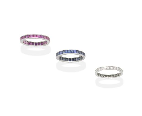 THREE RUBY, SAPPHIRE AND DIAMOND ETERNITY RINGSEach set with calibré-cut rubies, sapphires or single-cut diamonds, diamonds a