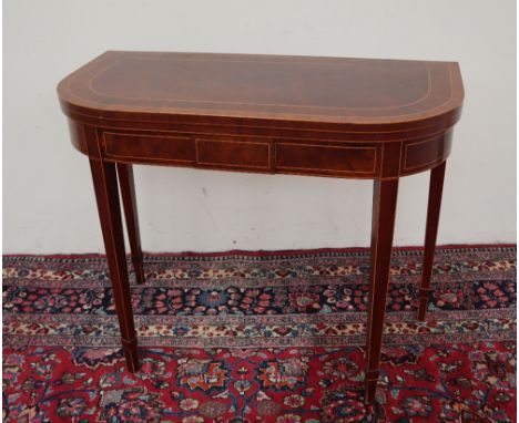 A 19th century mahogany card table with a D shaped cross banded top on square tapering legs, 91.5cm wide x 46cm deep x 73.5cm