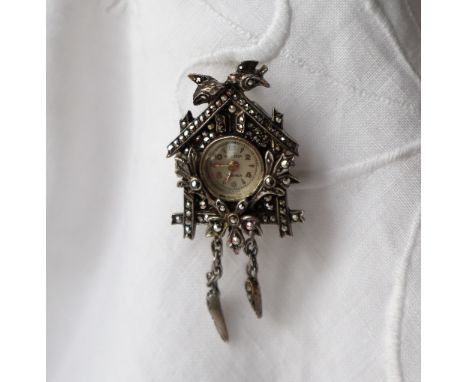 A marcasite brooch watch, in the form of a cuckoo clock, the silvered dial with Arabic numerals and batons, inscribed Buchere