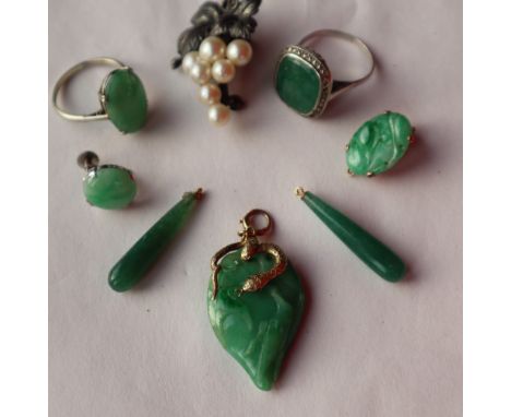 A jade pendant of pear shape, carved with birds and leaves with a yellow metal snake fitting 30mm long together with two jade