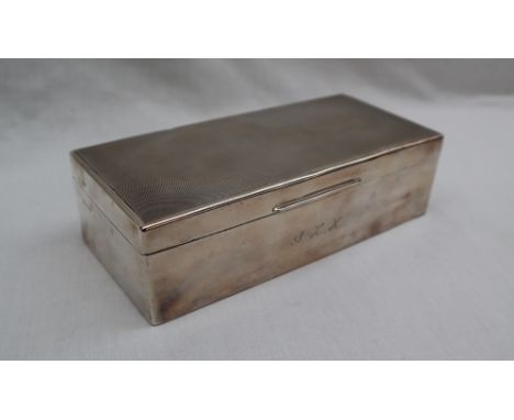 An Elizabeth II silver cigarette case, of rectangular form with engine turned decoration to the top the interior with divider