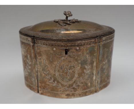 A George III white metal tea caddy, of shaped oval form, the domed hinged lid with a floral finial, the body decorated with l