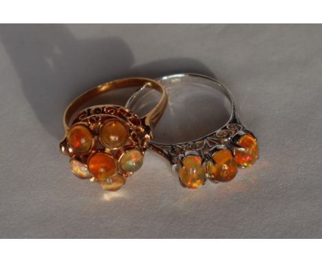 An orange opal dress ring set with six cabochon opals to a yellow metal setting marked 18k, size N1/2 together with a three s