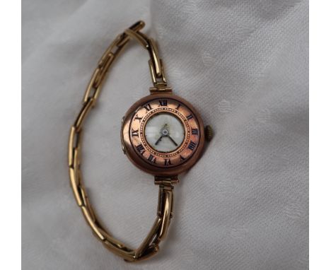 A lady's 9ct gold wristwatch, the chapter ring with blue enamel Roman numerals, on an expanding bracelet CONDITION REPORT: No