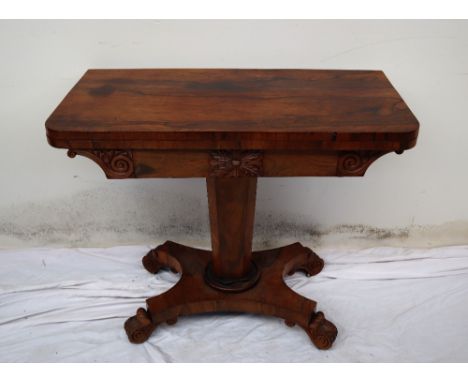 A Victorian rosewood card table, the rectangular top with rounded corners, enclosing a baize interior on a octagonal column, 