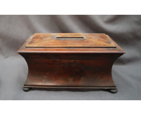 A Victorian rosewood tea caddy, the rectangular hinged top enclosing a pair of lidded compartments and a central well, with c