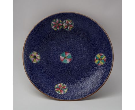 A Chinese porcelain dish, with an incised blue ground, inset with polychrome enamel roundels, 15.5cm diameter, seal mark to t