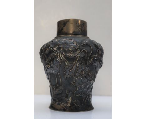 A Chinese silver tea caddy, with a domed cover above an inverted baluster body decorated with flowerheads and leaves, by Wosh