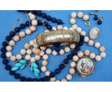 A French yellow metal necklace set with blue and white semi precious stones together with a gilt metal hinged bangle, bead ne