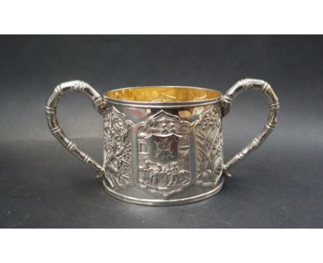 A Chinese silver twin handled sugar basin, decorated with a figural scene and panels of bamboo, fruit and flowers with bamboo